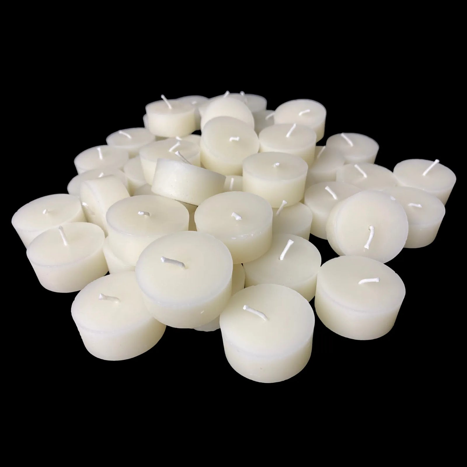 White beeswax tea light refills in a low pile, hand poured with cotton wicks