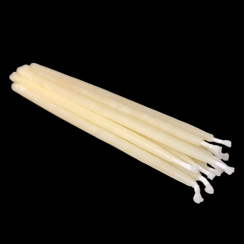 Cappings beeswax birthday taper candles in natural beige laid flat with cotton wicks