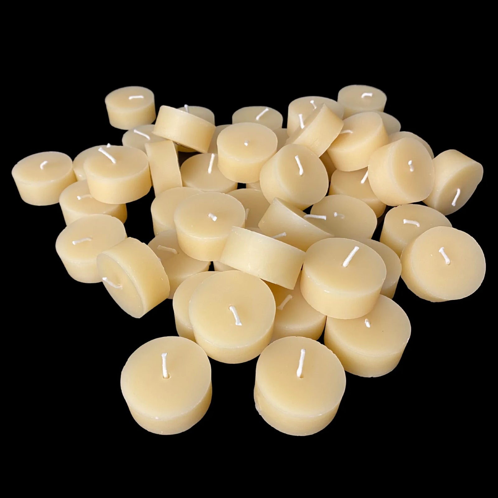 Cappings beeswax tea lights in a large pile, 100% beeswax bulk set