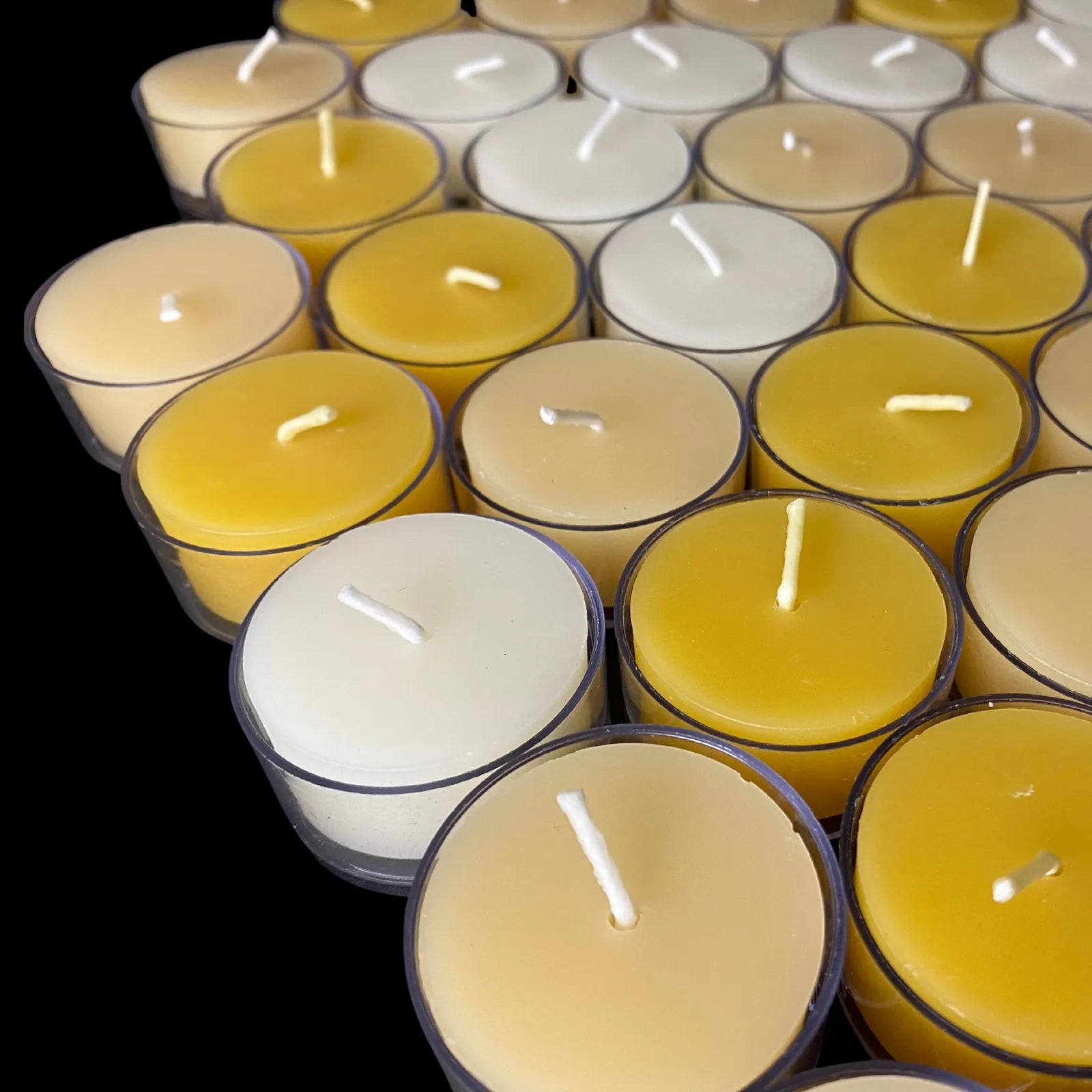 Cappings beeswax tea lights shown with white and yellow in clear cups, 1.54 in