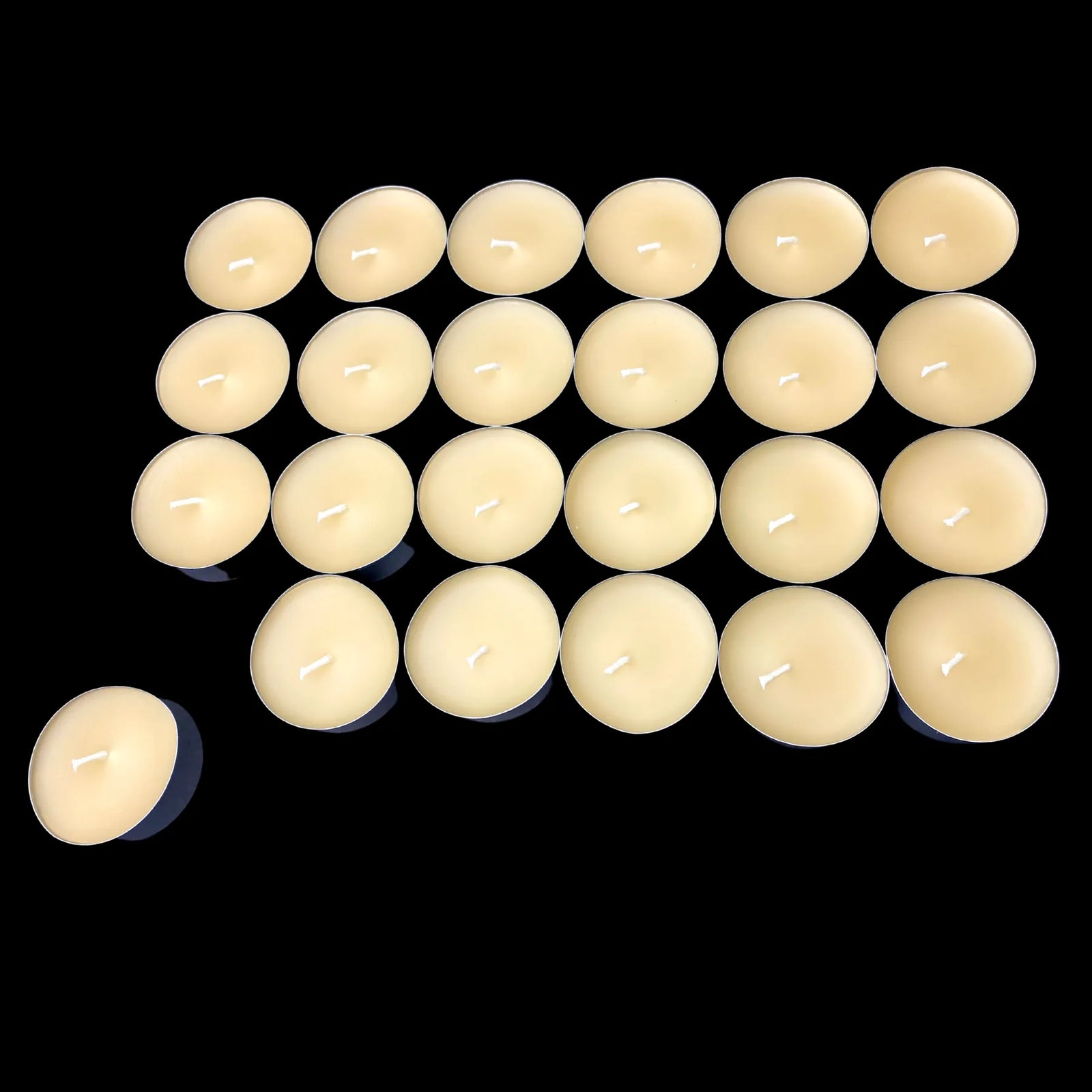 Low batch of cappings beeswax candles in aluminum cups, pure honey scent