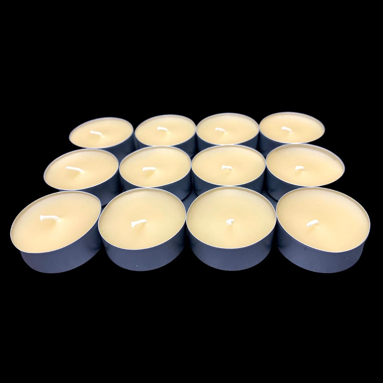 Honey-toned cappings beeswax tea lights in aluminum cups, small group, cotton wick