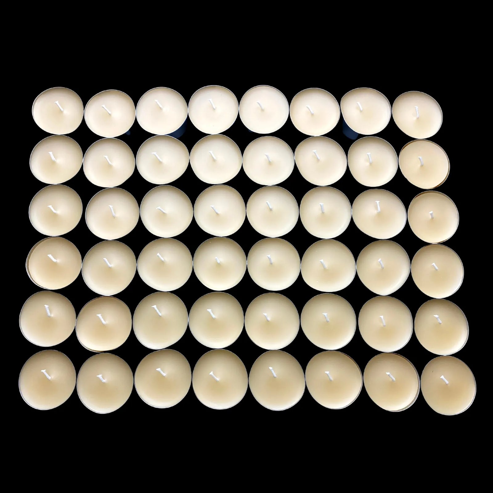 Wide spread of cappings beeswax tea lights in aluminum cups, hand poured cotton wick