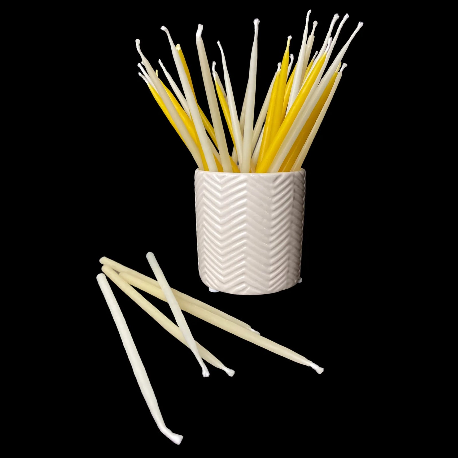 Beeswax birthday candles styled with a ceramic vessel for a simple table centerpiece