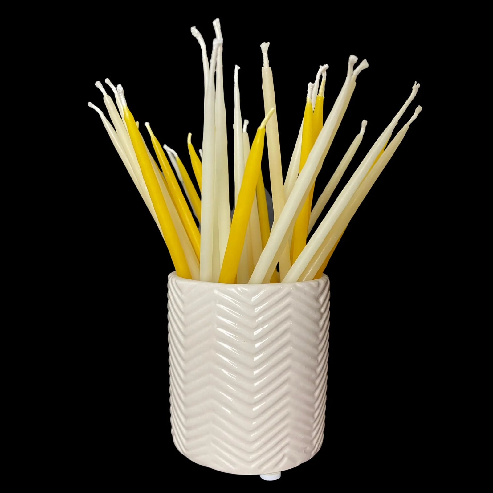 Hand dipped beeswax birthday candles bouquet in a white ceramic vessel for celebrations