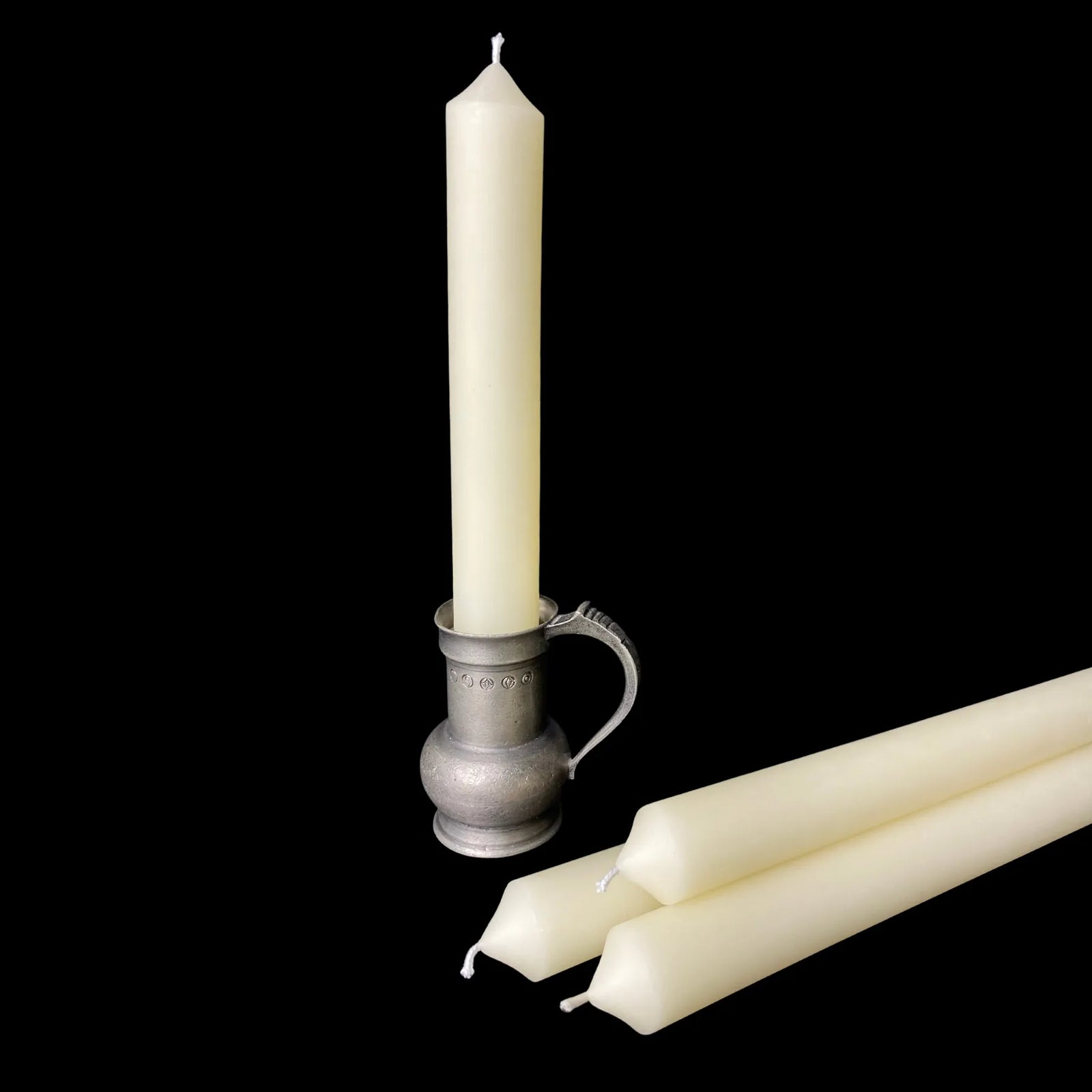 Ivory beeswax taper in a decorative pewter chamberstick holder, one inch thick