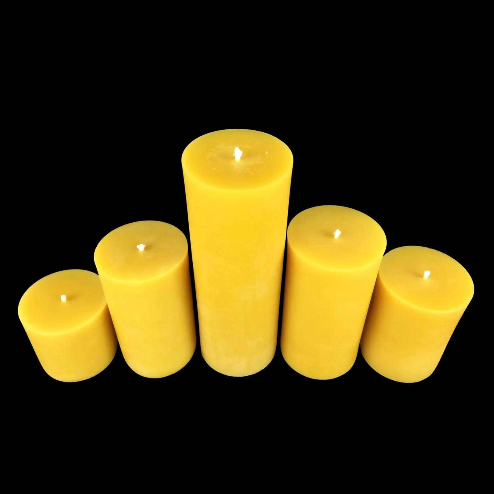 Handcrafted yellow beeswax pillars, 3 in wide, fanned by height, perfect for events and gifting.