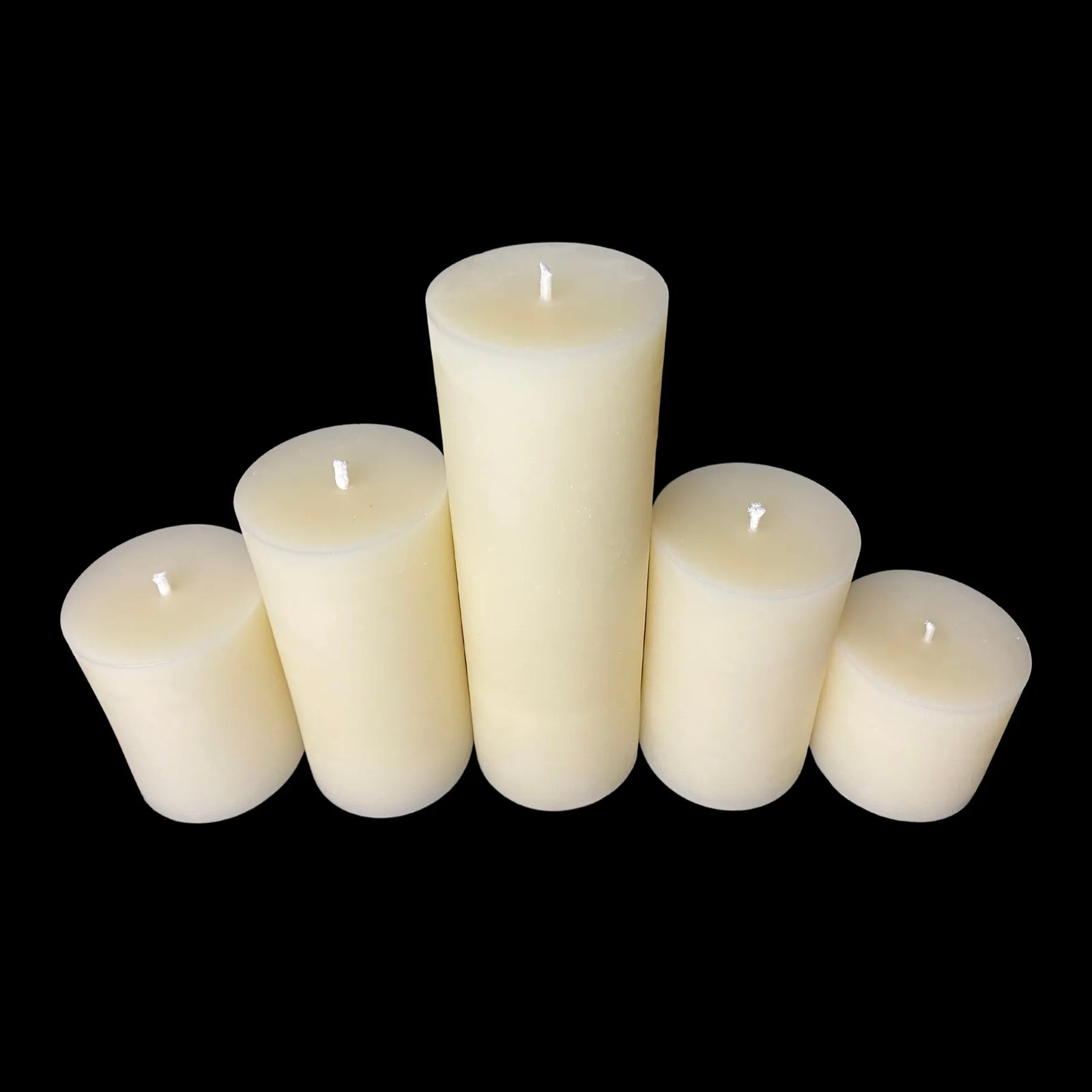 Set of 5 natural beeswax pillar candles, in different heights for minimalist decor.