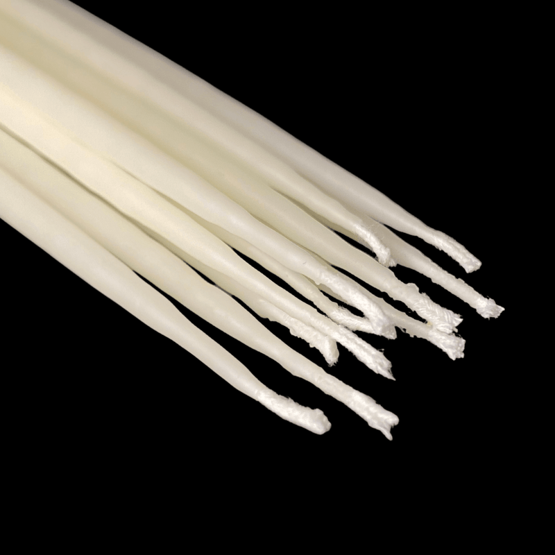 White beeswax birthday taper candles laid flat made with 100% pure beeswax