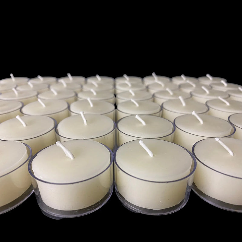 White beeswax tea lights in clear cups spread on black, set of 96, honey scented