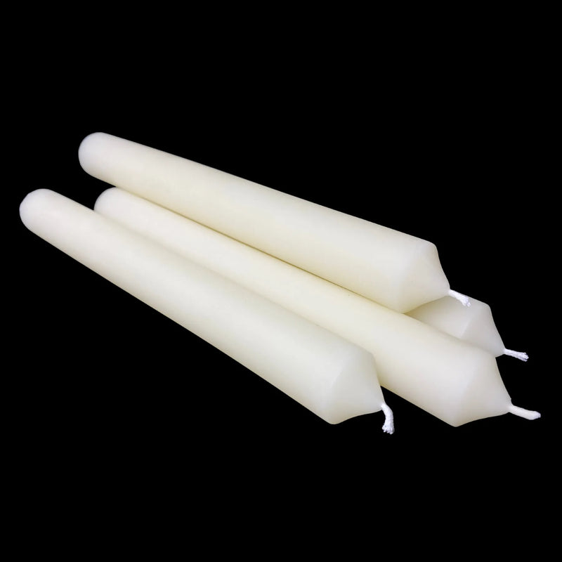 Four white beeswax dinner tapers crossed with cotton wicks facing front, one inch wide