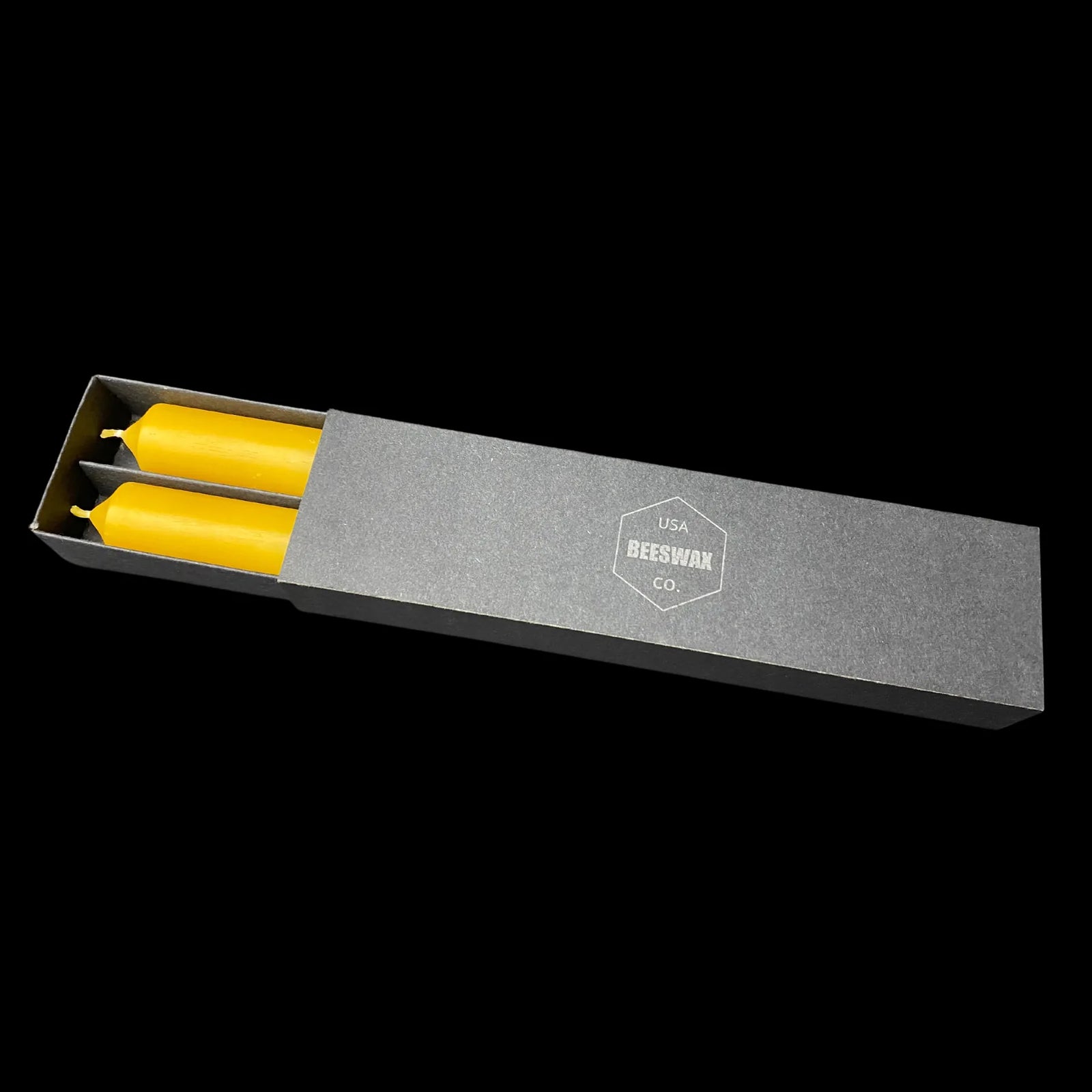 Yellow beeswax tapers tucked into an open presentation box, 1 in diameter, made in USA