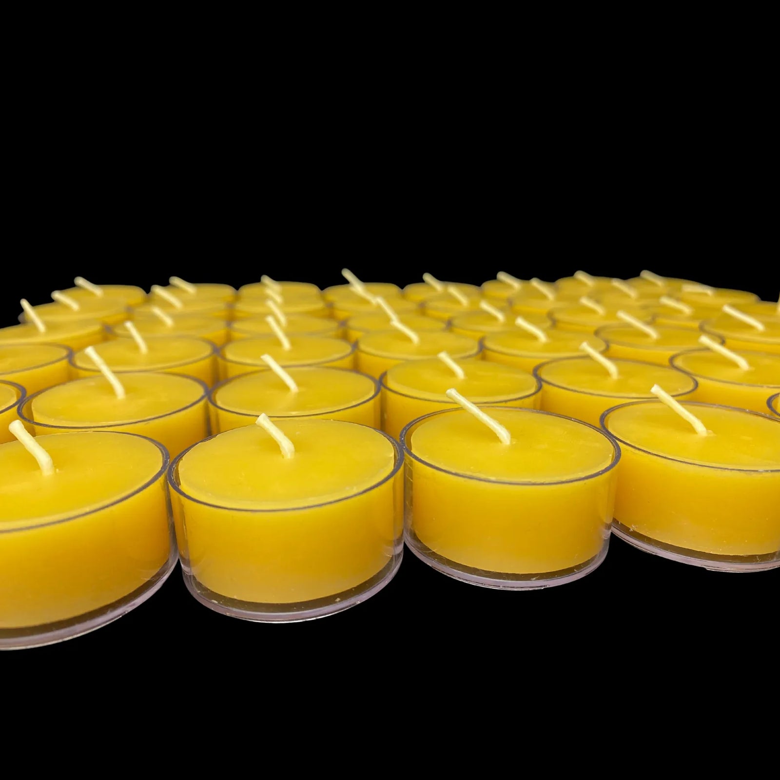 Yellow beeswax tea lights in clear cups on black, set of 6, made in USA