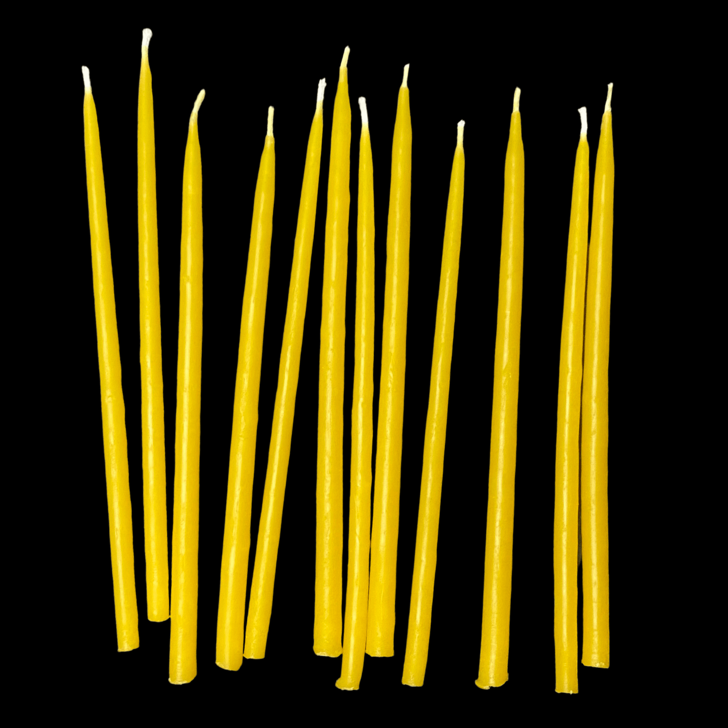 Six inch yellow beeswax birthday taper candles standing upright hand poured by beekeepers