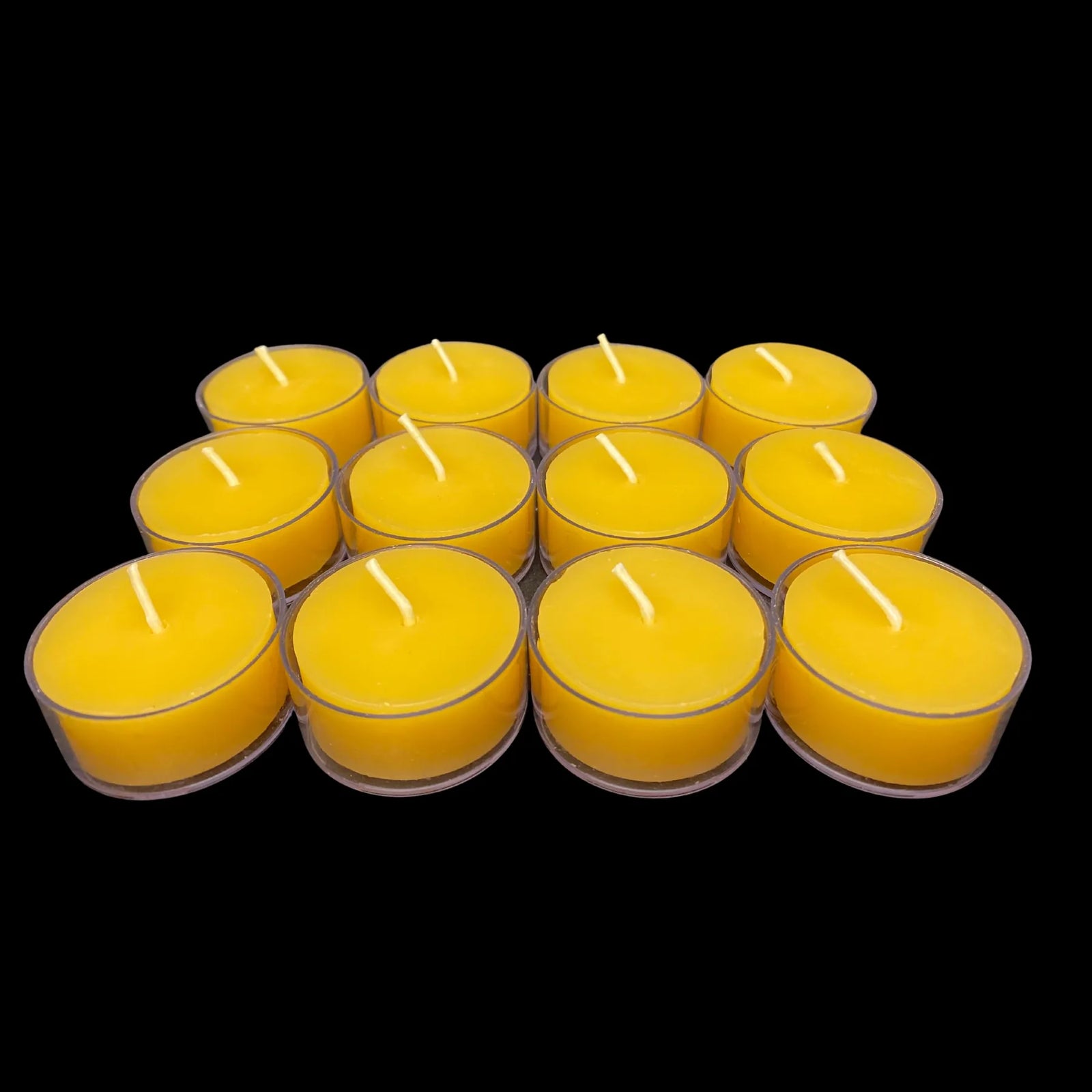 Golden yellow beeswax tea lights in clear cups, rich honey color, set of 12