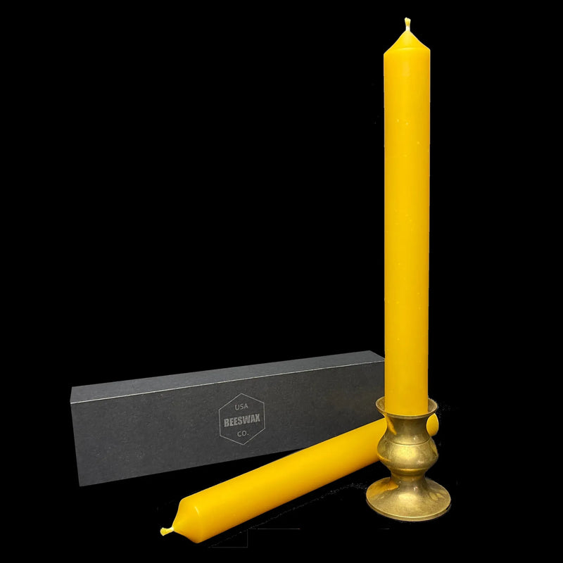 Yellow beeswax taper in a brass candlestick holder, 1 inch thick, clean-burning