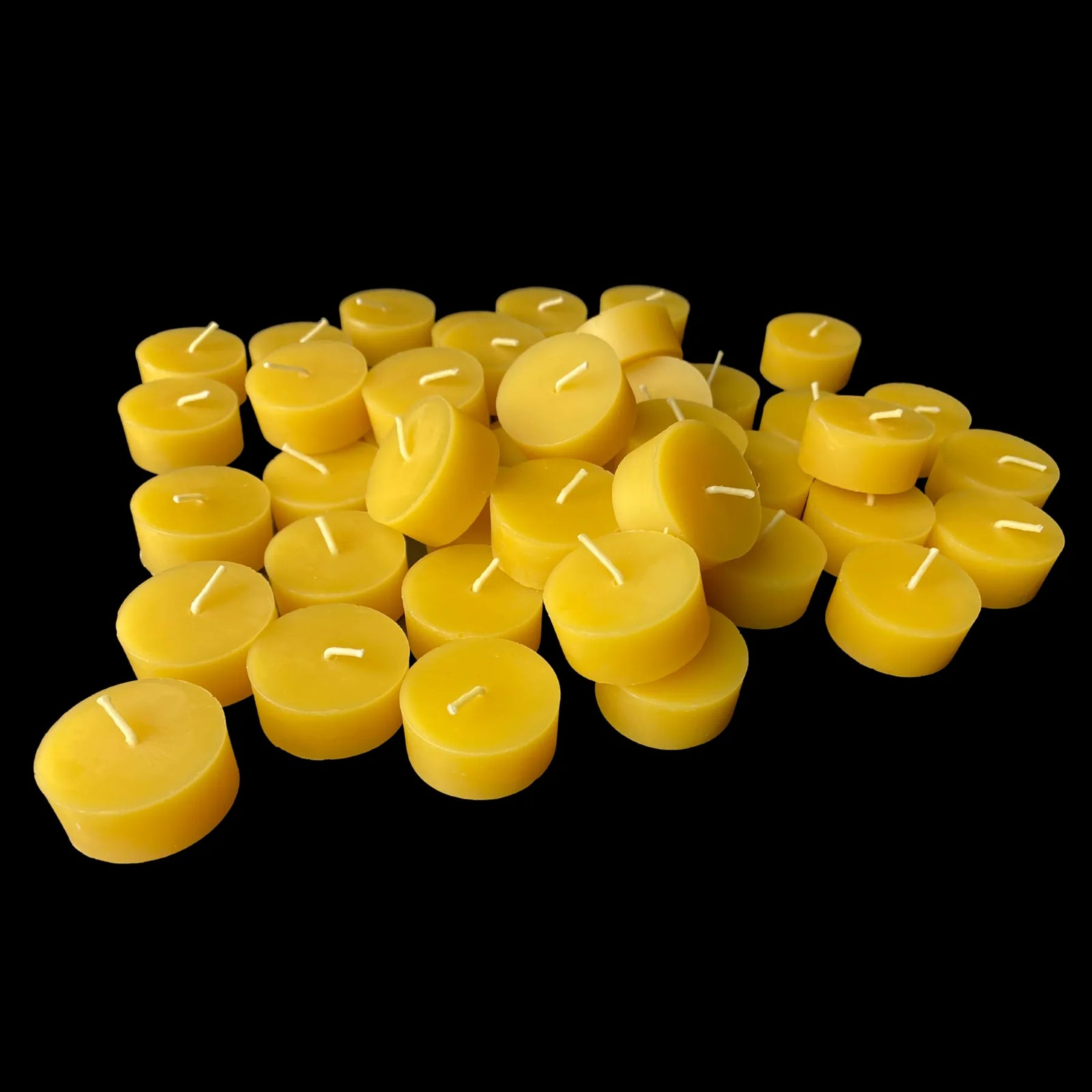 Yellow beeswax tea lights lined in rows, wedding quantity, honey scented