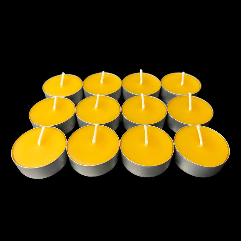 Golden yellow beeswax tea lights in aluminum cups in a small grid, 100% beeswax