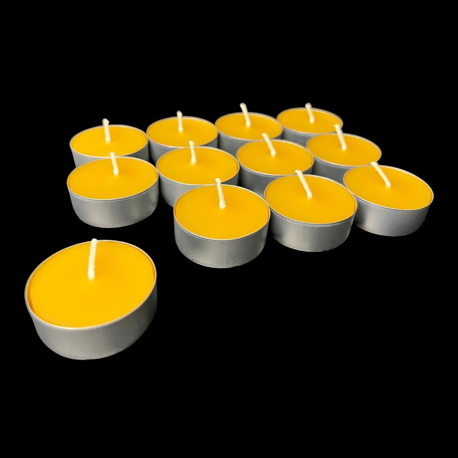 Yellow beeswax tea lights in aluminum cups, rich golden color, hand poured cotton wick